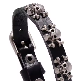 Black leather bracelet with silver skull charms on a white background